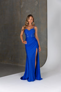 Woman wearing a blue evening gown with a high slit on a white background
