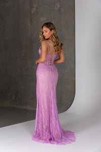 Woman wearing a purple lace dress against a neutral background